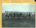 The 1908 Georgetown University baseball team stands in a tightly packed row, wearing jackets and sweaters, and with some wearing their baseball gloves