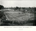 a black and white photograph of a football game. in the photograph, a large crowd is gathered around a field that is divided into a grid. below the photograph, there is a caption that reads, "Georgetown - Virginia game, November 10, 1906."