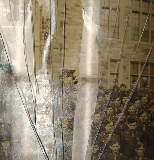 photograph of army cadets in front of Healy Hall covered in broken glass before conservation treatment