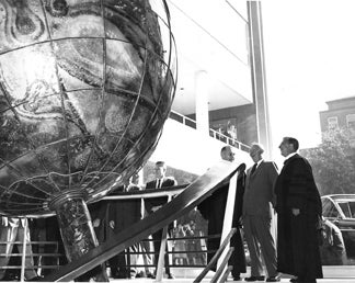 President Eisenhower admires the Plexiglas globe at the Walsh Building dedication, October 13, 1958. Standing to his right is Georgetown University President Edward B. Bunn, S.J. From the Georgetown University Archives.