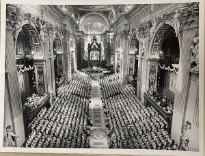 Image of the interior of St. Peter's Basilica with bishops seated on either side of the sanctuary