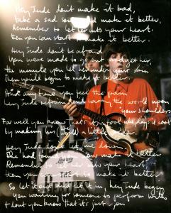 "Hey Jude" lyrics written in white over top of a picture of The Beatles