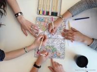Group of people coloring a coloring page
