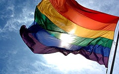 The sun shining through a rainbow flag