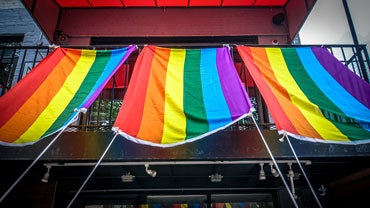 Pride flags hanging from a balcony