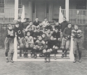 a black and white photograph of the 1905 Varsity football Squad, sitting on the steps of Old North.