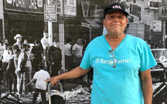 Gustavo points to himself pictured as a participant in the Young Lords' Garbage Offensive in 1969, from the StoryMap Community Control and Gentrification in NYC