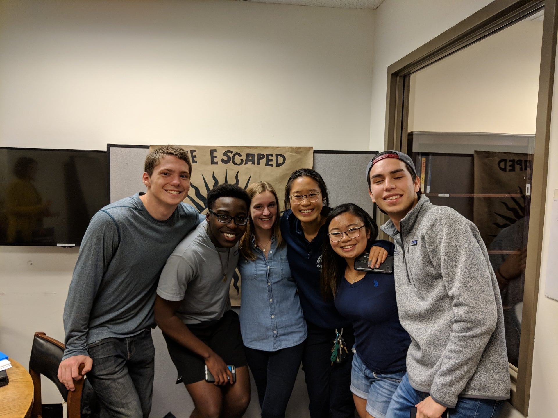 Students celebrating escaping the Lauinger Library Escape Room