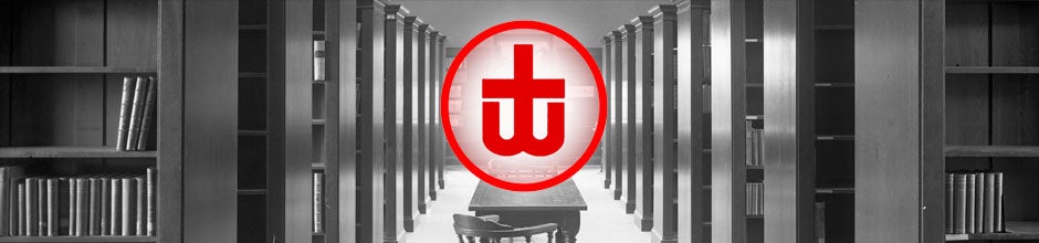 Looking down the middle of the old Woodstock library stacks, withe the Woodstock Library logo.