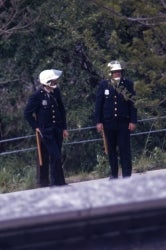Color photograph of two policemen with batons