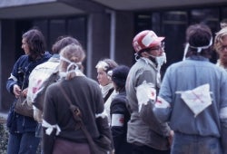 Color photograph of a group of medics wearing home-made arm bands with a red cross on them