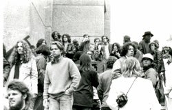 Black and white photograph of protesters on the steps of Lauinger Library