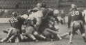 a black and white photograph in which Jim Castiglia dives over the Hampden-Sydney defense in the Hoya’s first win of the 1938 season, published in Ye Domesday Booke, 1939