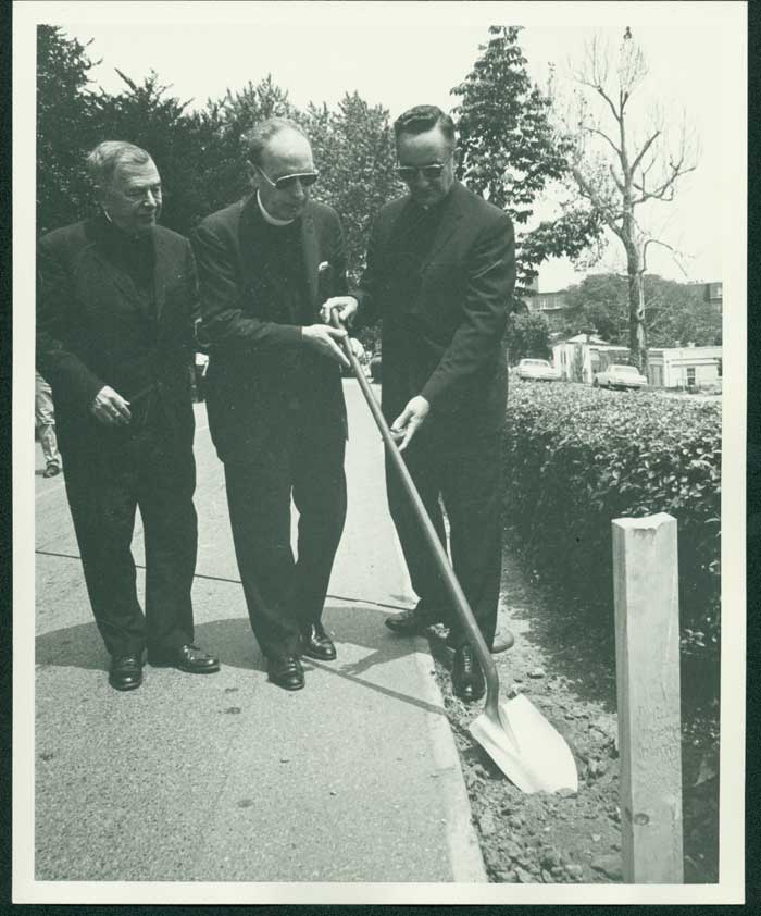 Chancellor Edward B. Bunn, S.J., Director of Libraries James B. Horigan, S.J., University President Gerard J. Campbell, S.J. hold a shovel at the groundbreaking ceremony