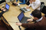 Students use their laptop computers in a group study room