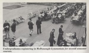 Black and white photograph of students registering.