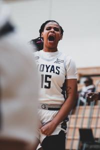 Color photograph of a female basketball player screaming