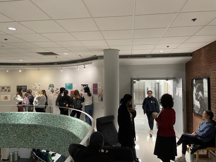 wide view of the exhibition with people walking about the space