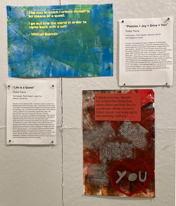 two posters hung on a white wall, one green and blue, the other red and grey