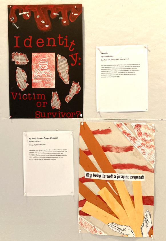 two muted, dark red and orange posters hung diagonally on a wall
