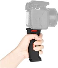 A hand holding a digital camera using the Pistol grip mount