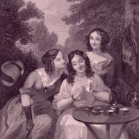 Three women pouring over a book