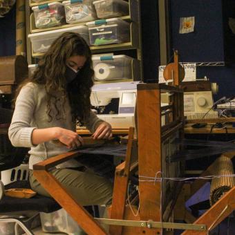 Catherine Dell'Olio weaves a project on the Maker Hub's Dorset loom