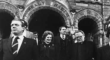 Black and white photo of Margaret Thatcher walking down the steps of Healy Hall