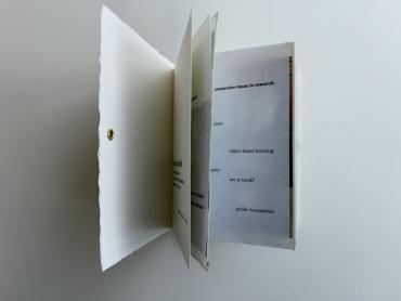 "Art in your hands" an artists'  book created by Anjelika Deogirikar. The book is fanned open to show several pages at once.