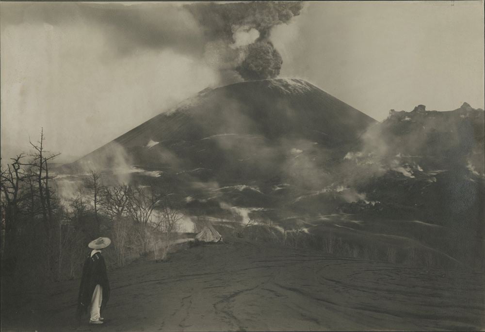 Man in sombrero looking at a volcano
